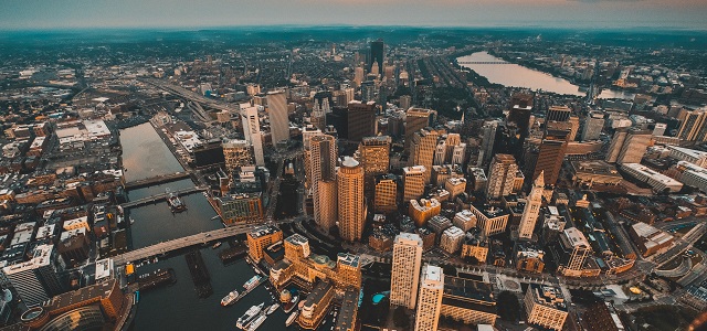 an aerial view of Boston, with buildings, water, and boats.