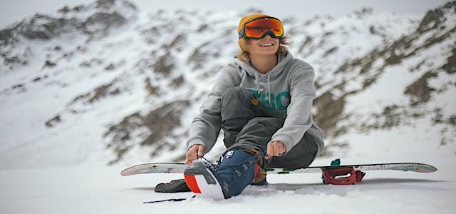 a girl on a snowboard enjoying a day at the slopes