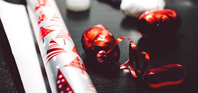 shiny red ribbon and christmas tree wrapping paper