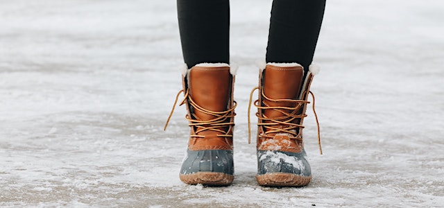 a pair of llbean boots on a snowy driveway