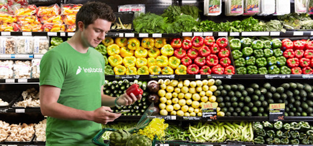A male shopper for InstaCart in Boston in the produce section of a grocery store.