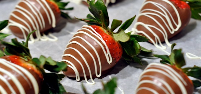 Fresh chocolate covered strawberries with a white chocolate drizzle.