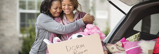 A mother and daughter hugging at a college move-in day.